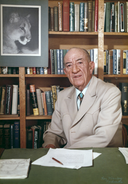 William Carr at his desk with portrait of George L. Mountainlion