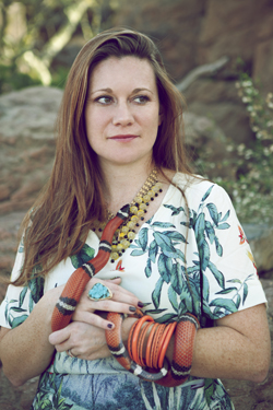 Keeper Catherine models a white leafy Buffalo Exchange dress with a snake