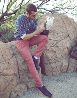 Keeper Wally models salmon Buffalo Exchange pants with a barn owl