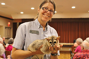 Educator Robin holds a ringtail