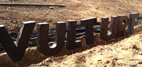 Vulture lettering set into ground
