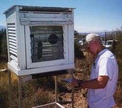 A Teen Volunteer checks the weather station