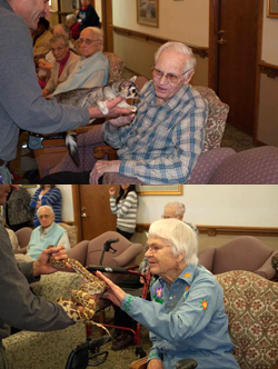 Senior Citizens pet a snake and a ringtail